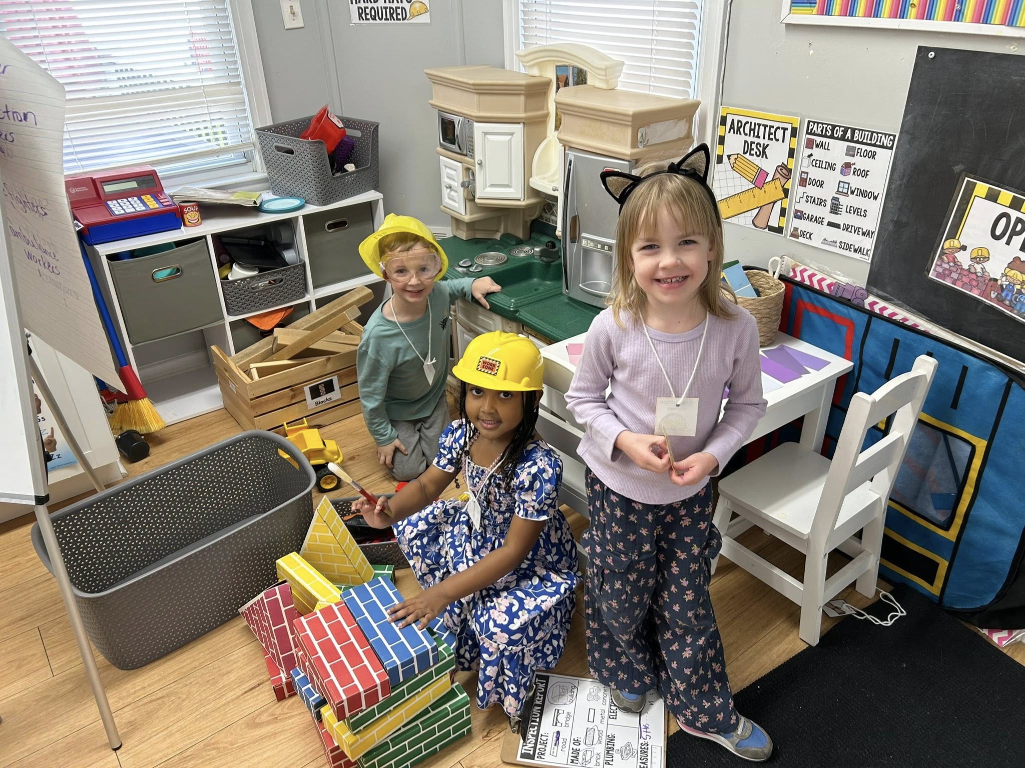 Three UPK children playing in a classroom.