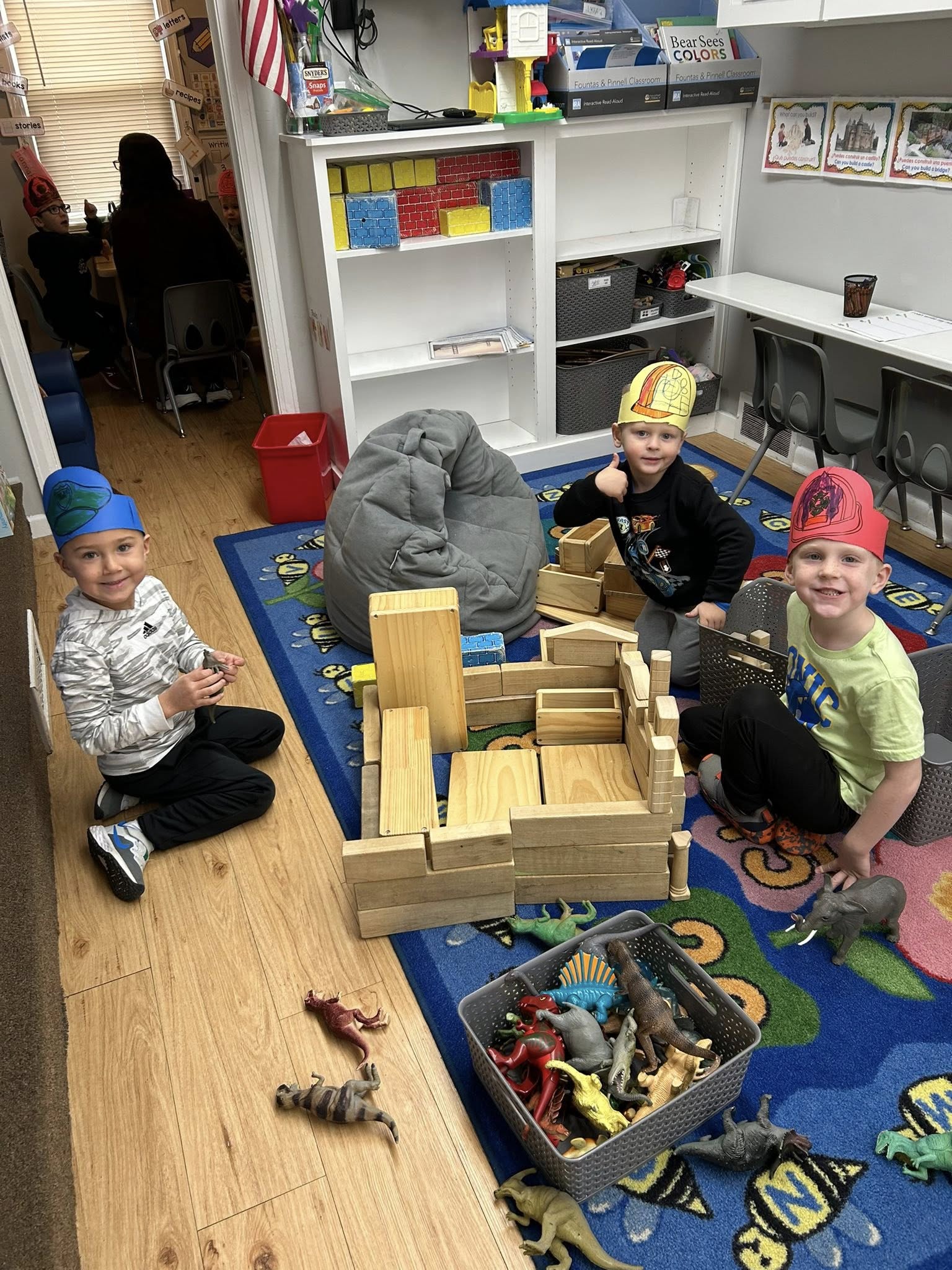 Three little boys playing with blocks.
