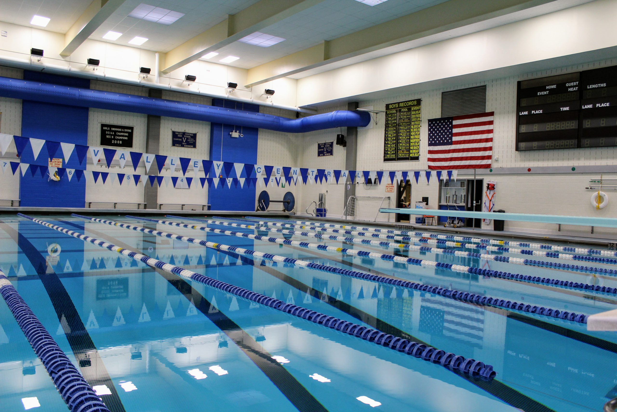 VC Pool showing the still water, lanes and deck with American Flag. There are blue and white flag banners above the water