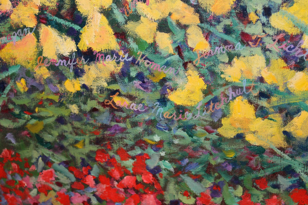 Detail from painting that is dedicated to the children lost in the 1989 EC tragedy. The detail shows red, purple and yellow flowers with the children's names written in the garden