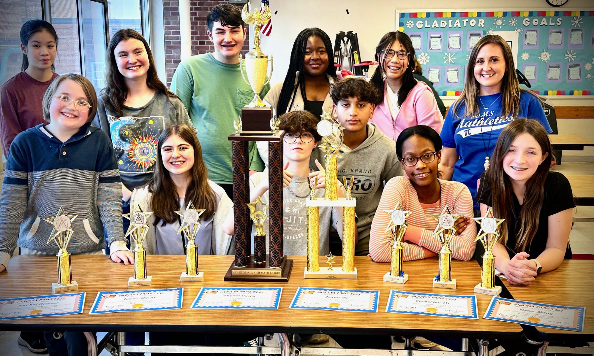 VCMS Math students are seated with the trophies that they won in the 2024 Jr. Math League Finals.