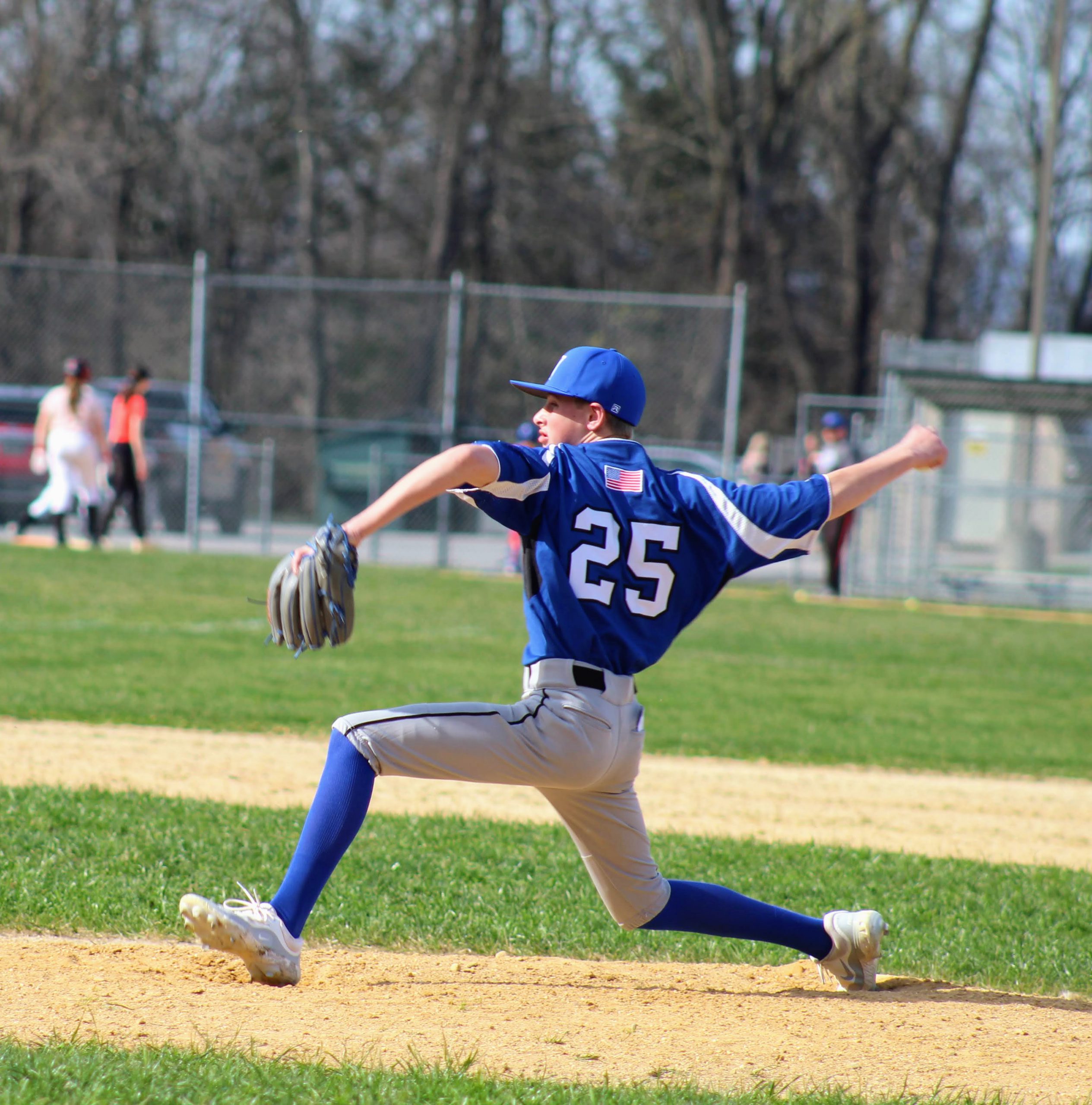 JV Baseball player number 25 pitches the ball from the pritcher's mound