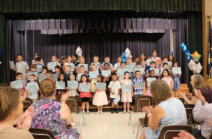 Students from East Coldenham smile for a photo with their certificates. 