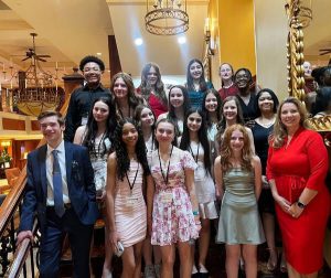Students standing on a staircase posing for a photo. 