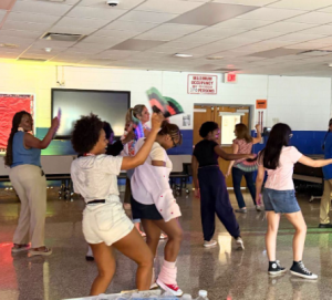 Students are dancing in a cafeteria for the Juneteenth celebration at Valley Central. 