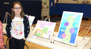 Valley Central student standing with art