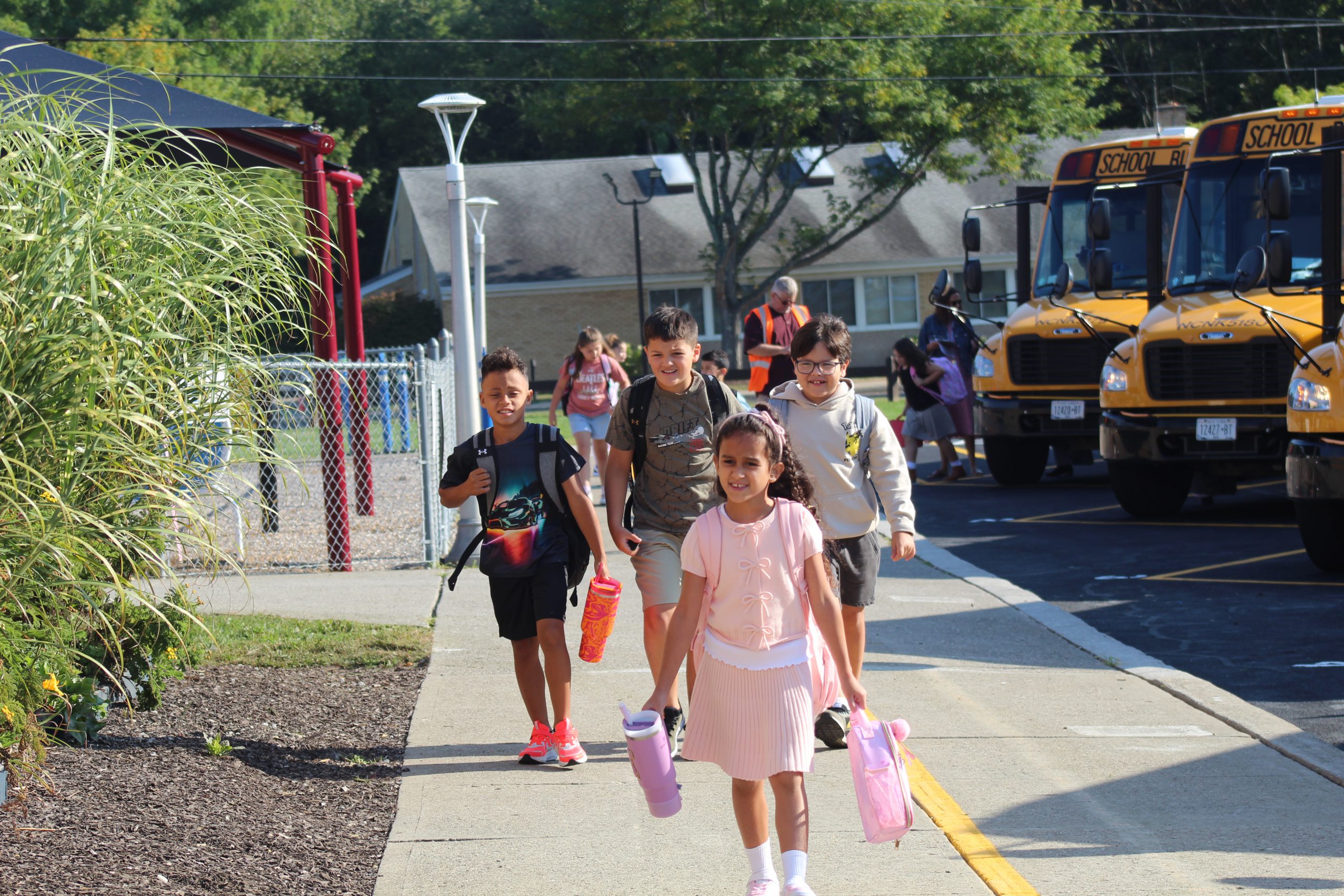 A group of students walk into school on the first day. 