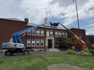 Montgomery Elementary School got a new roof. Two machines parked in front of building.