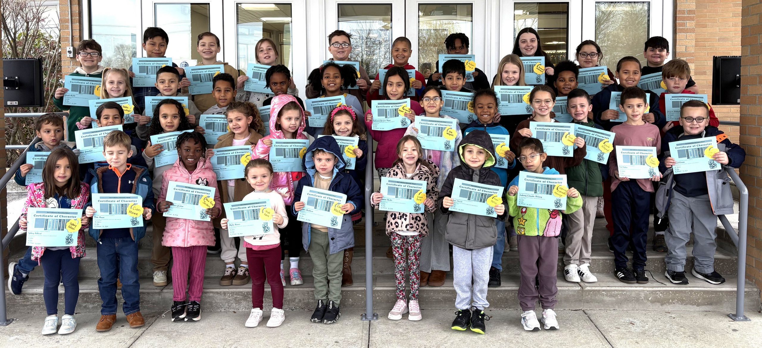 Large group of students holding certificates.