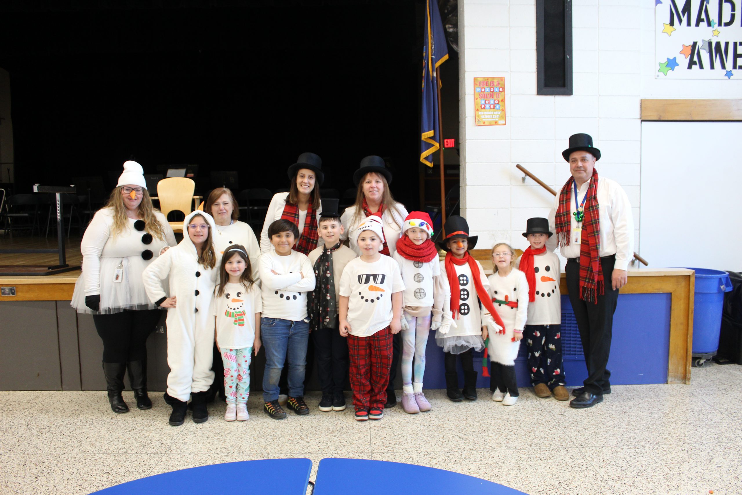 Group of kids and teachers dressed as Frosty.
