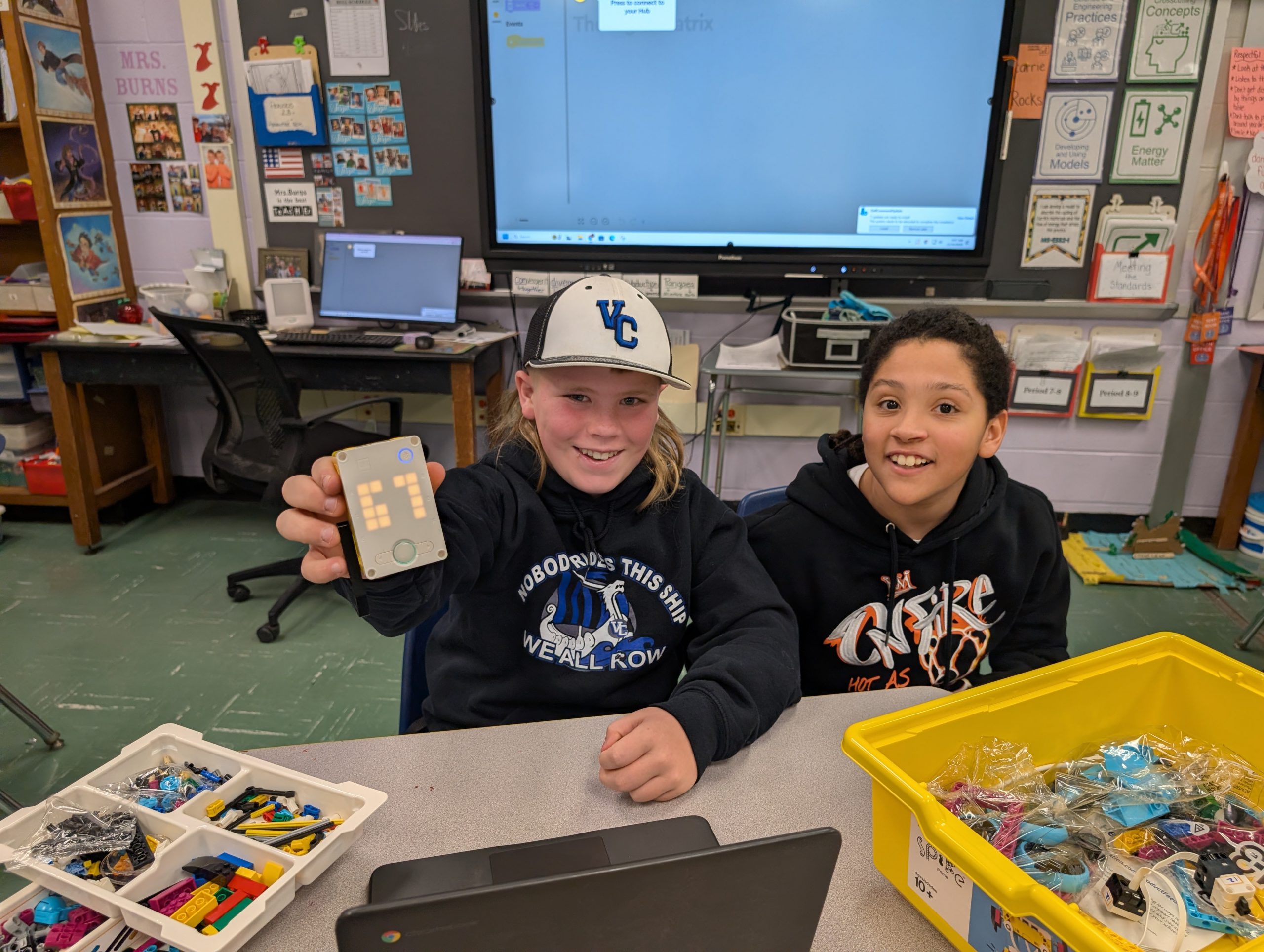 Boy and girl doing a STEAM project with legos.