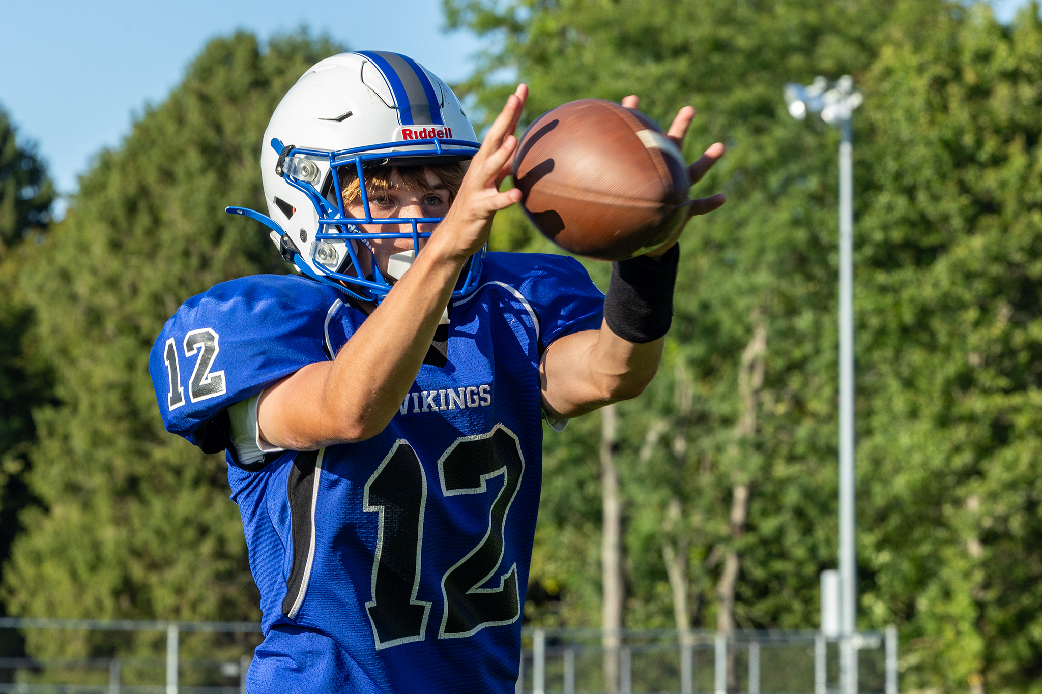 A receiver catches the football